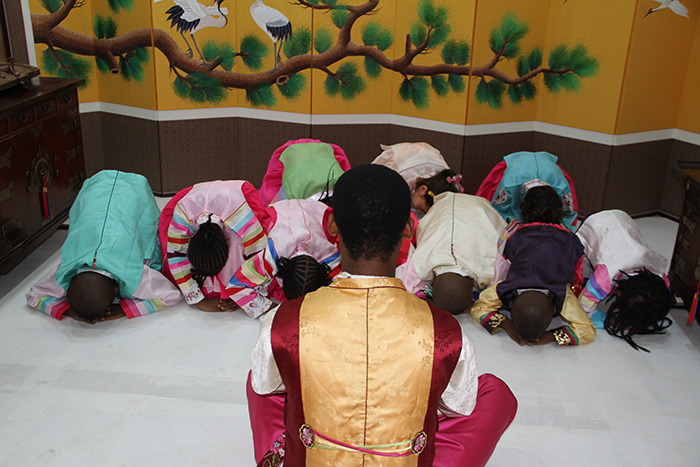 Children perform a ceremonial <i>sebae</i> New Year's bow (세배) to their elder in a wish for good luck in the new year.